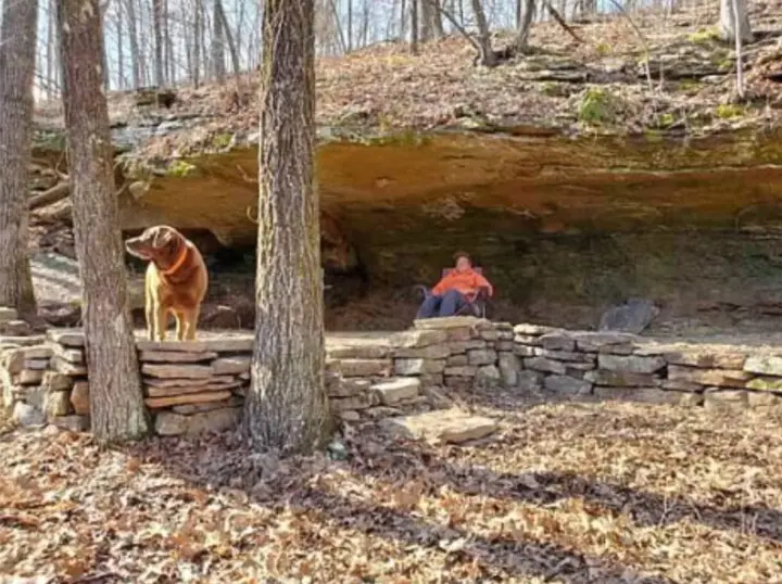 Relaxing under a cliff with a dog